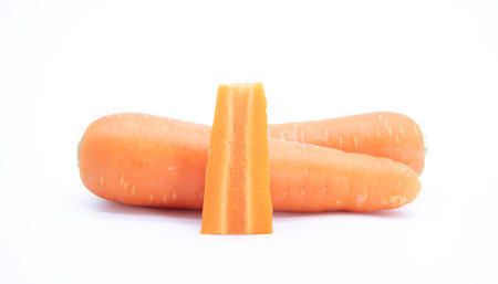 whole carrot and cut carrot pieces isolated on white background as package design elementの写真素材