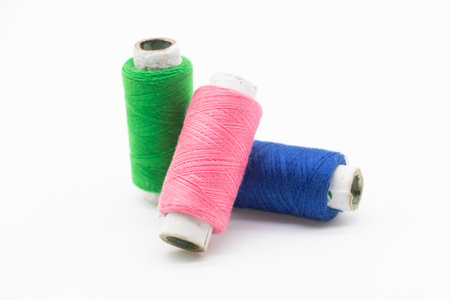 Colorful yarn on spool, yarn on tube, cotton, wool, linen thread, polyester selective focus on red spoolの写真素材
