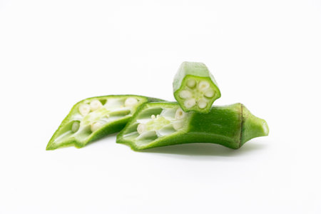 okra or Lady Finger pieces over on white banckground
