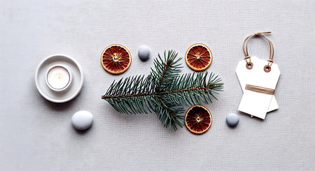 Christmas or New Year decoration with fir branches, dry oranges and candles on a white backgroundの素材