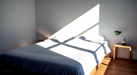 Interior of a modern bedroom with white walls and a wooden floorの素材