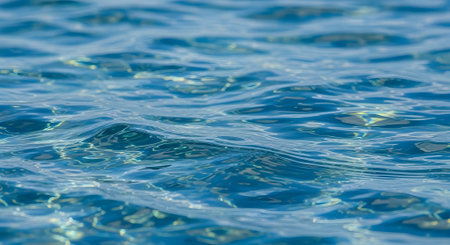 Blue water surface with sun reflections. Abstract background and texture for design.の素材