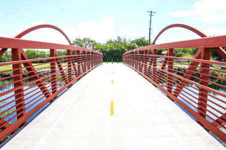Red bridge located outside of Biscayne National Park in Homestead, Florida, Bridge leading to fishing spots, Bridge over a canal.の写真素材