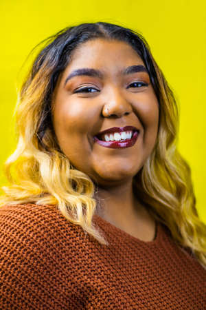 Head shot portrait of a biracial woman wearing a burnt orange sweater, Black woman portrait, Plus size model posing, Plus size model portrait,の写真素材