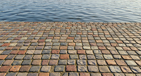 Paving stones on the embankment of the city river.