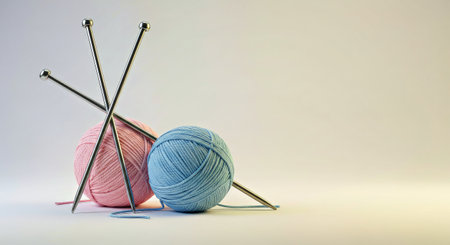 Three balls of yarn and knitting needles on a white background with space for textの写真素材