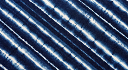 Seamless tie-dye pattern of indigo color on white silk fabric. Abstract background and texture for design.の写真素材