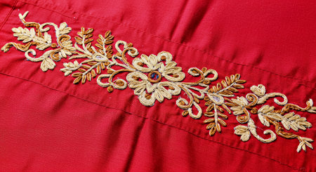 Thai style embroidery on red fabric texture background, Thailand.の写真素材