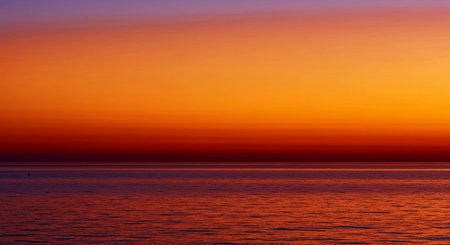 Peaceful minimal sunset design features calm endless ocean horizon under a soft colorful evening sky