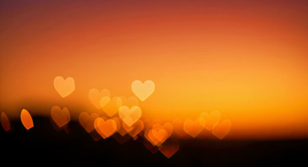 Beautiful Bokeh Heart Shaped Lights Overlay on a Warm Sunset Gradient Background
