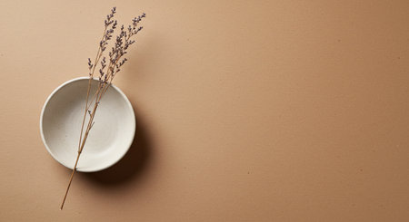 Dry Plant in Minimalist Ceramic Bowl Kraft Paper Background Flat Layの写真素材