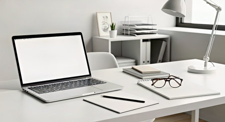 Flat View of Laptop Glasses and Writing Pad on a Modern Student Desk Workplaceの写真素材