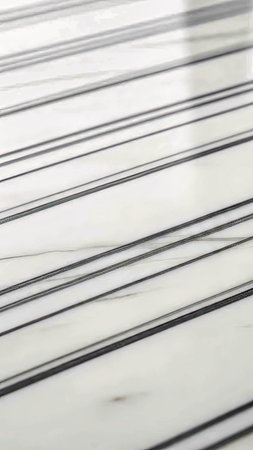 A high-contrast black and white background featuring sharp diagonal stripes and a polished, glossy...