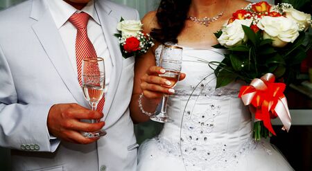 the groom, the bride, the couple, Bridal bouquet, closeup of the hands, wedding rings, champagne glassesの写真素材