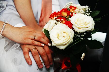 the groom, the bride, the couple, Bridal bouquet, closeup of the hands, wedding rings, champagne glassesの写真素材