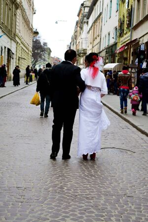 the bride and groom close up the house, walking in the city hdの写真素材