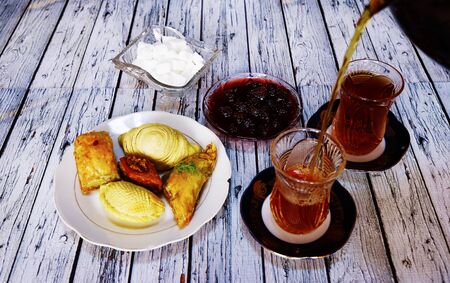 Sweet baklava on plate with tea on table in roomの写真素材