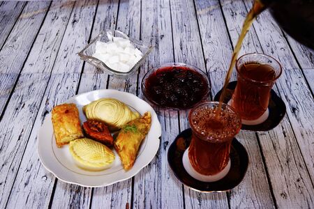 Sweet baklava on plate with tea on table in roomの写真素材