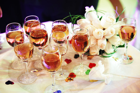 Champagne in hands of new married couple closeupの写真素材