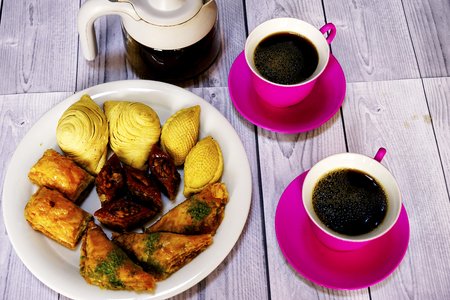Eastern Turkish sweets baklava and cup of coffee on wooden tableの写真素材