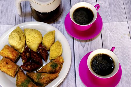 Eastern Turkish sweets baklava and cup of coffee on wooden tableの写真素材