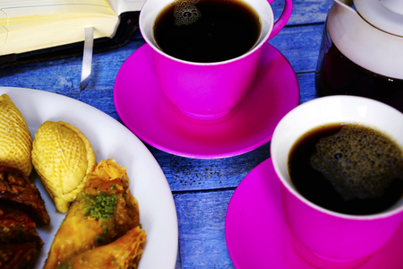 Eastern Turkish sweets baklava and cup of coffee on wooden tableの写真素材