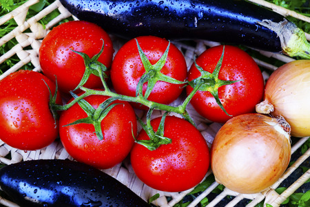 different ripe vegetables on wicker plates on the grass. healthy foodsの写真素材