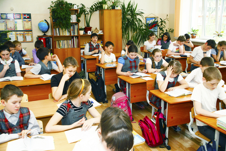 Moscow,Russia-August 16,2016-Little schoolboy sitting behind school desk during lesson in Russian schoolのeditorial素材