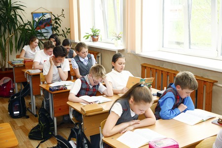 Moscow,Russia-August 16,2016-Little schoolboy sitting behind school desk during lesson in Russian schoolのeditorial素材