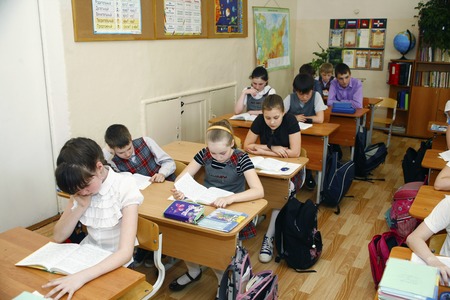 Moscow,Russia-August 16,2016-Little schoolboy sitting behind school desk during lesson in Russian schoolのeditorial素材