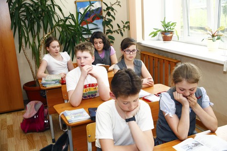 Moscow,Russia-August 16,2016-Little schoolboy sitting behind school desk during lesson in Russian schoolのeditorial素材