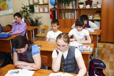Moscow,Russia-August 16,2016-Little schoolboy sitting behind school desk during lesson in Russian schoolのeditorial素材