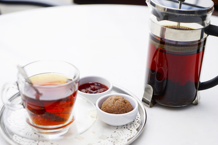 kettle, cups with tea and Eastern Turkish sweets on the table in a cafeの写真素材