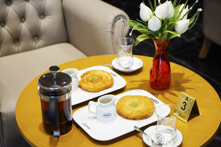 kettle, cups with tea and Eastern Turkish sweets on the table in a cafe