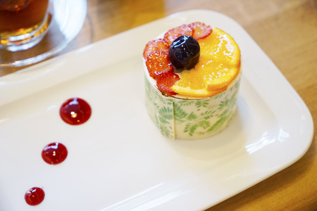 Oriental Turkish pastries with cream and fruit on a white plateの写真素材