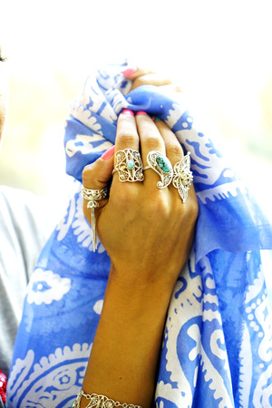 Beautiful fashion east woman portrait.Asian girl in a African violet headscarf praying. Red nail. Arabian beauty.の写真素材