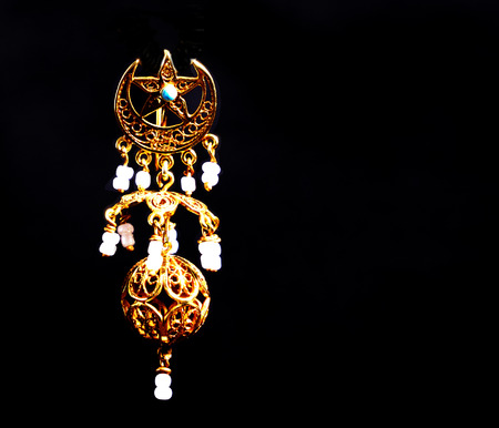 beautiful gold ornaments on a dark background. gold jewelry for women. necklace and earringsの写真素材