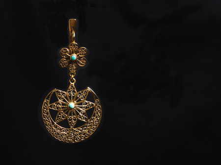 beautiful gold ornaments on a dark background. gold jewelry for women. necklace and earringsの写真素材