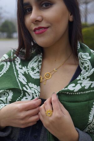 beautiful girl with Eastern Turkish headscarves and gold antique vintage jewelleryの写真素材