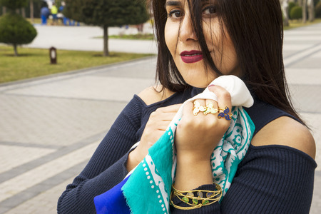 beautiful girl with Eastern Turkish headscarves and gold antique jewelleryの写真素材