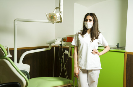 Portrait of female dentist .She standing in her dentist office.の写真素材
