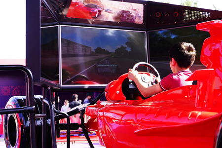 BAKU, AZERBAIJAN - MAY 17, 2016: Public race car Simulator on Ferrari F1 with large audience at Expo...