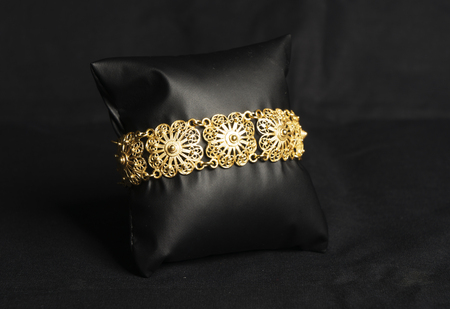 female Golden Eastern Turkish vintage women's handmade jewelry on a black background. bracelets,の写真素材