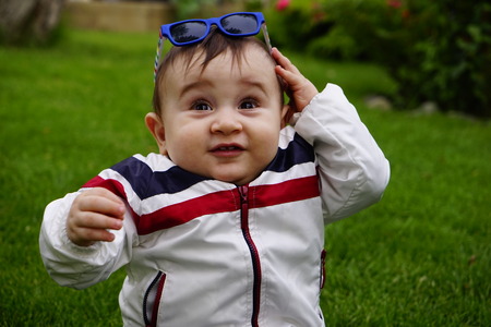 portrait of cute little boy sittingの写真素材