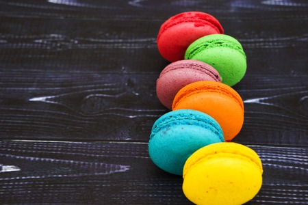 Sweet and colorful french macaroons or macaron on black backgroundの写真素材