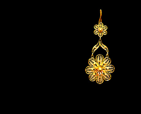 beautiful Oriental gold Turkish jewelry womens earrings black backgroundの写真素材