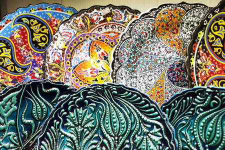 multi-colored decorative Turkish Oriental ornamental ceramic plates, dishes ware on the shelvesの写真素材