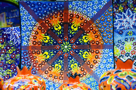 multi-colored decorative Turkish Oriental ornamental ceramic plates, dishes ware on the shelvesの写真素材