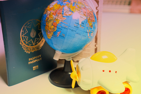 traveling concept,passport globe and toy airplane on the white backgroundの写真素材