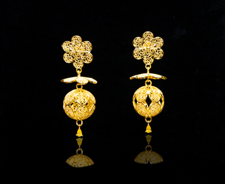 beautiful vintage gold Turkish jewelry womens earrings black backgroundの写真素材